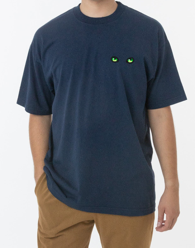 Green Cat Eyes on a Navy T-Shirt